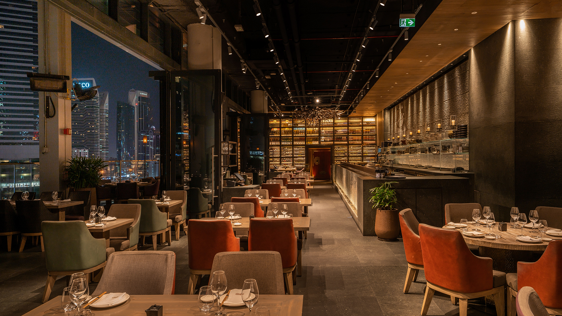 CLAP DIFC Dubai restaurant interior fit-out and MEP works featuring luxury dining spaces, open kitchen, bar, lounge, and rooftop terrace with Burj Khalifa views